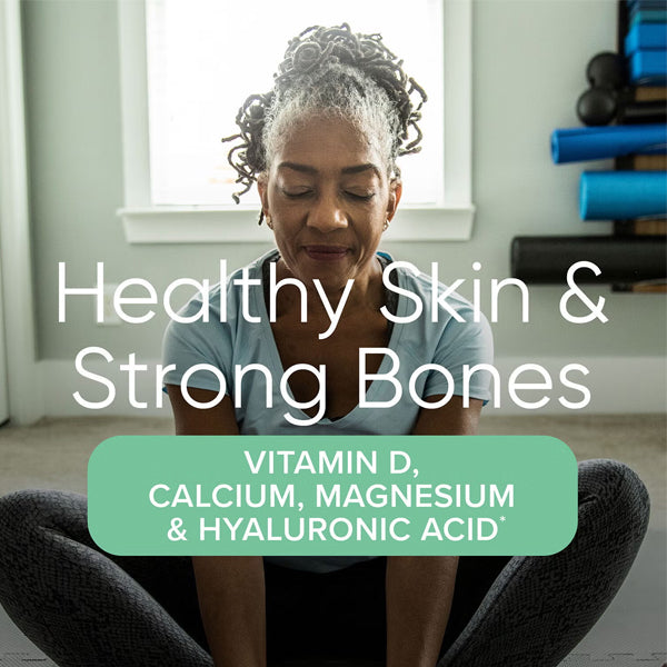 Healthy woman taking multivitamins for bone and brain support