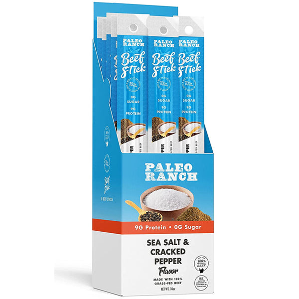 Paleo Ranch grass-fed beef protein sticks on a wooden table, showcasing their natural appearance