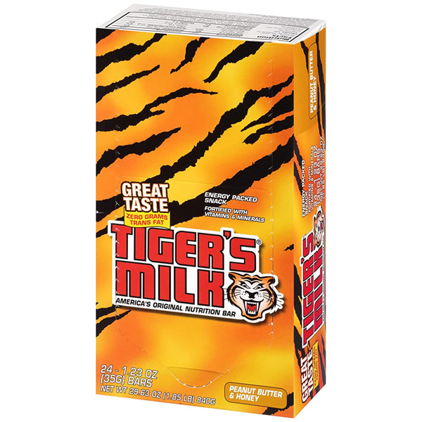 Tiger's Milk energy nutrition bar displayed on a wooden table, showcasing its multi-layered texture.
