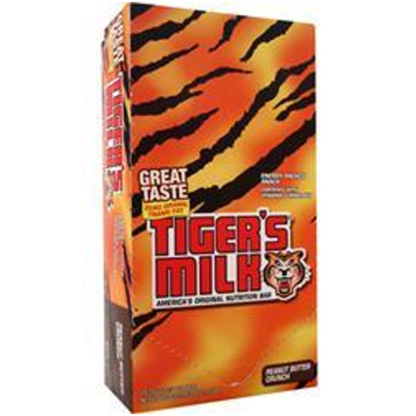 A person enjoying a Tigers Milk energy bar during a hike, highlighting its portability and energy-boosting properties.